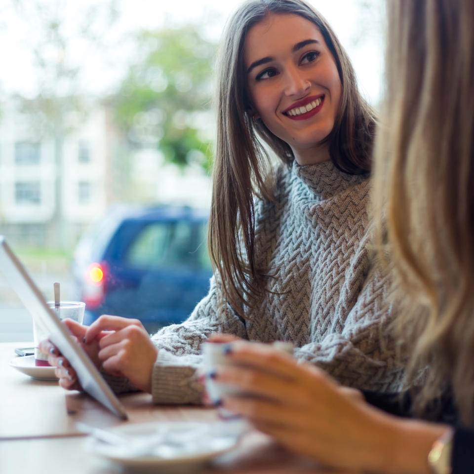 beautiful-young-women-using-digital-tablet-coffee-shop